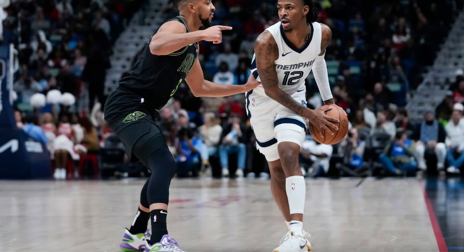 Memphis Grizzlies guard Ja Morant (12) looks to pass around New Orleans Pelicans guard CJ McCollum (3) in the first half of an NBA basketball game in New Orleans, Tuesday, Dec. 19, 2023.